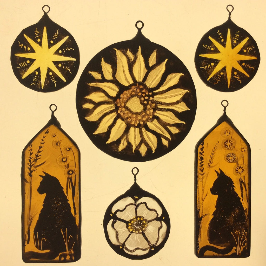 Set of decorative items with sunflower, star, cat, and flower designs on a light box  background.
