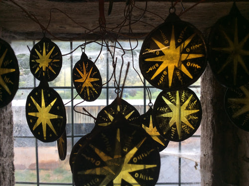 Decorative stained glass hanging decors with star designs in a rustic setting