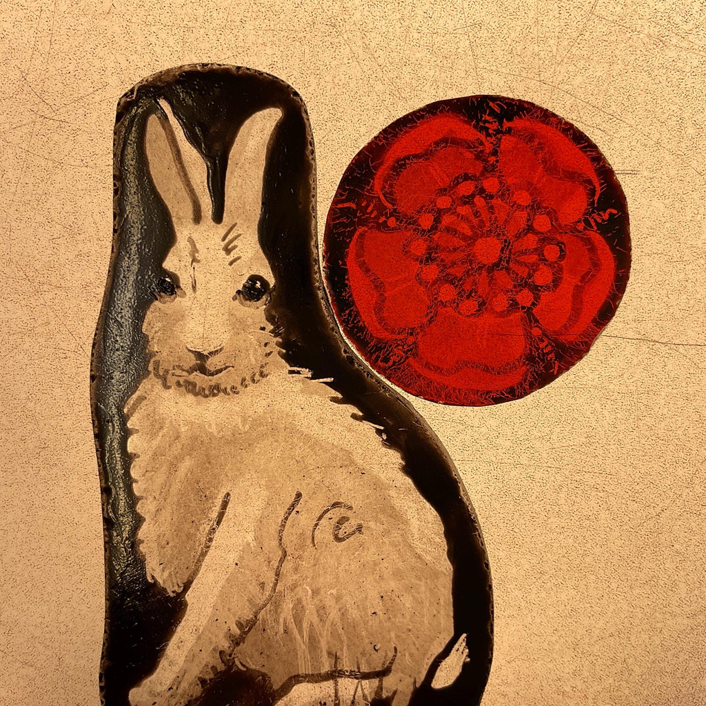 Stained glass rabbit design and a red circular stained glass Tudor rose on a light box