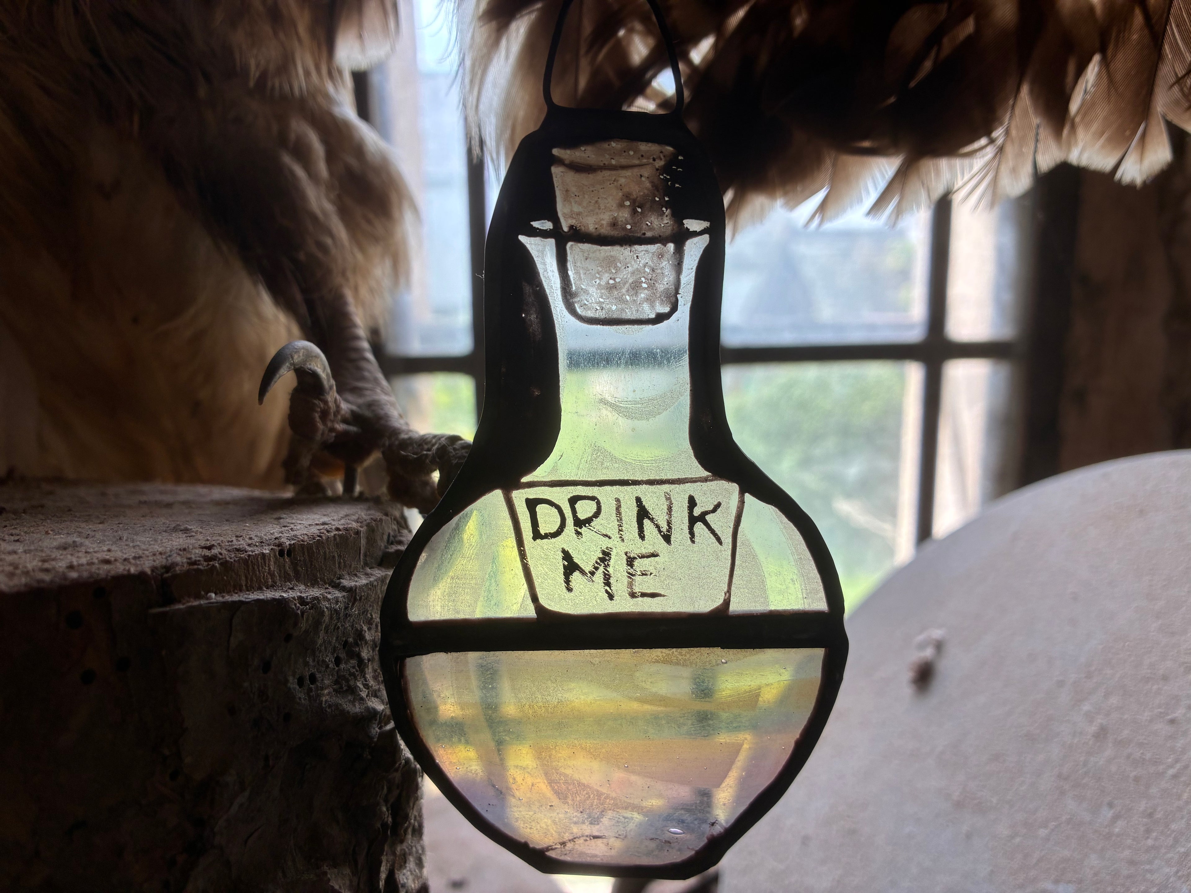 Glass stained glass bottle suncatcher with  DRINK ME text hand painted and kiln fired