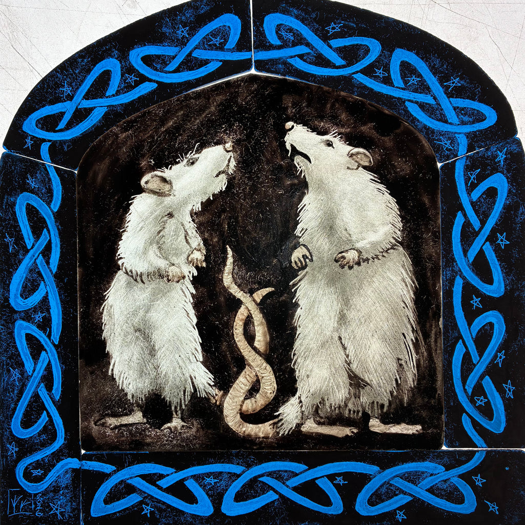 A “work in progress” image of the square decorative artwork showing two white rats facing each other inside a dark arched frame, with a blue Celtic knot border and small star details around the edge.  It is possible to see all six pieces of glass which make up the stained glass panel.  Shown on a light box.