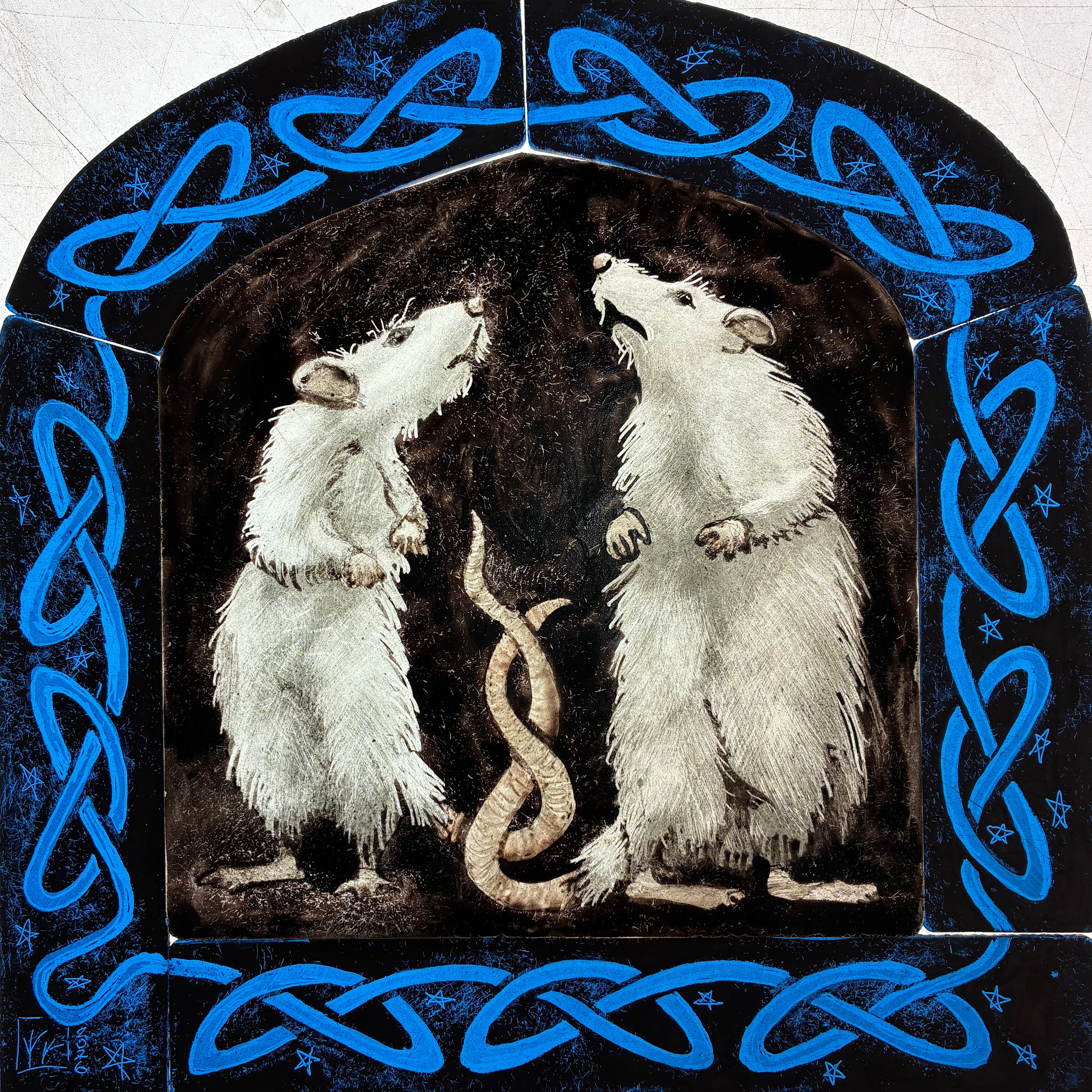 A “work in progress” image of the square decorative artwork showing two white rats facing each other inside a dark arched frame, with a blue Celtic knot border and small star details around the edge.  It is possible to see all six pieces of glass which make up the stained glass panel.  Shown on a light box.