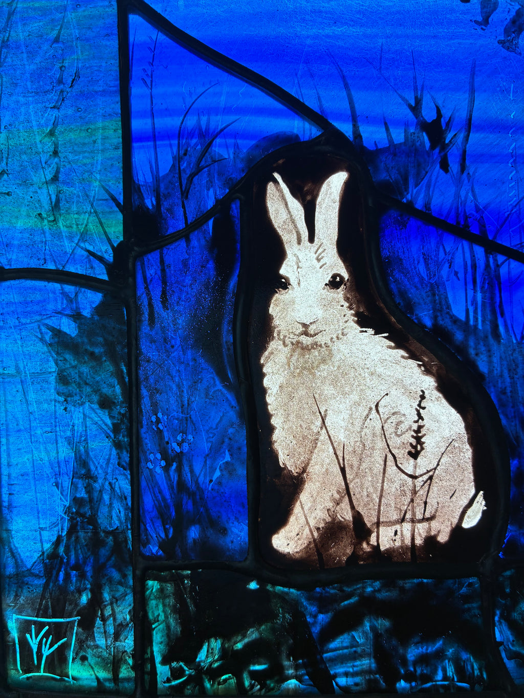 A detail of the stained glass painting featuring a rabbit  centred against a vivid blue background with black brushstrokes and organic dark shapes.  Lower left is the artist signature in a box.