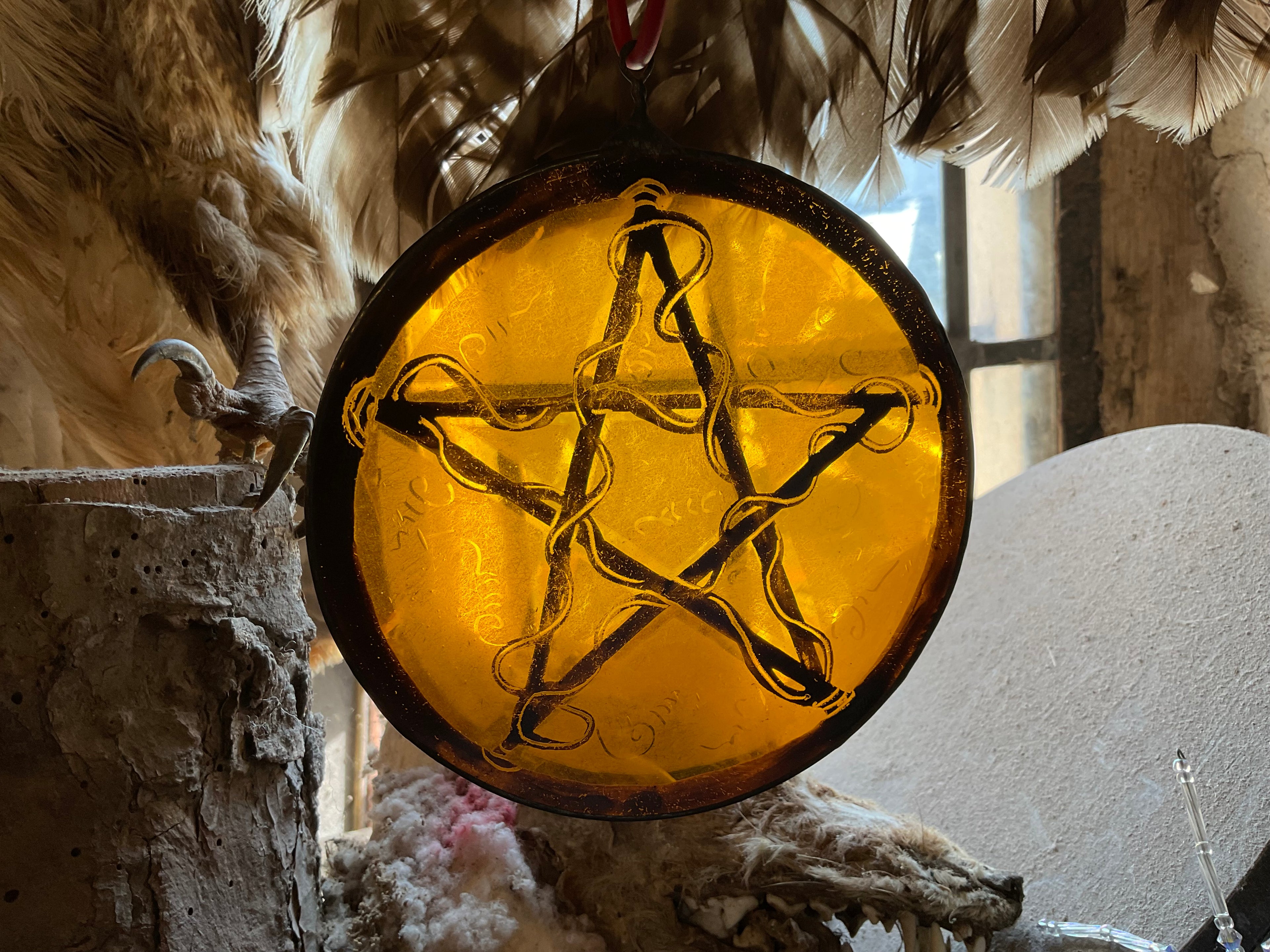Pentacle stained glass window decoration in amber