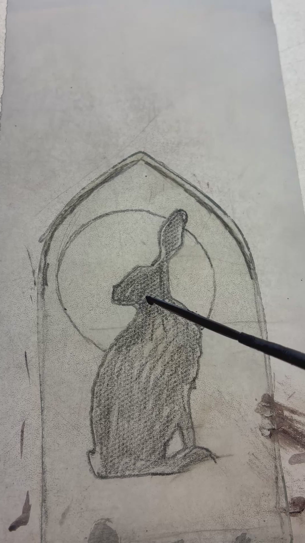 Painting the hare on up cycled glass, showing brush strokes.  