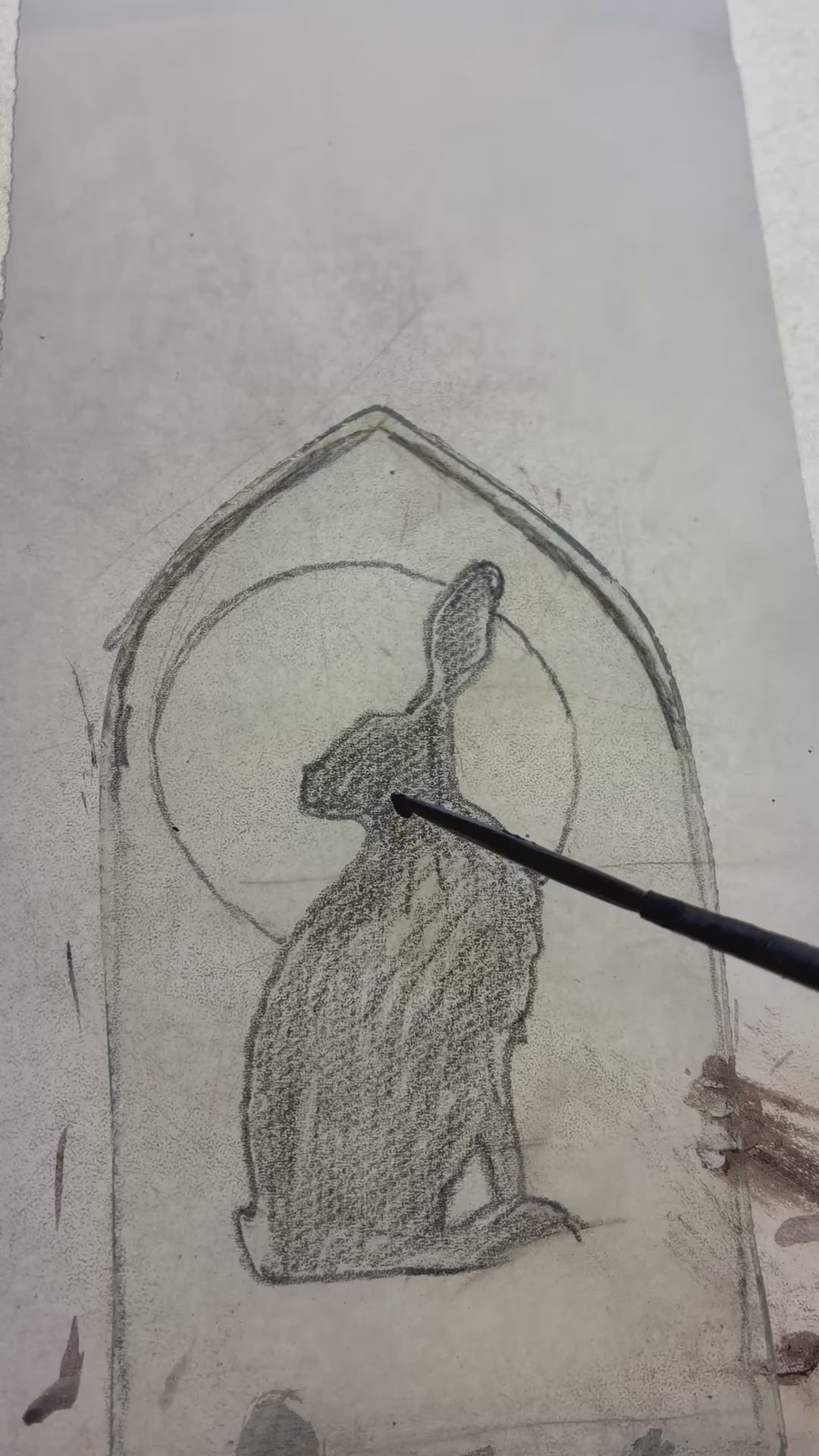 Painting the hare on up cycled glass, showing brush strokes.  